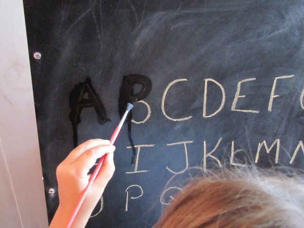 Create an easy tracing activity with a chalkboard and paintbrush.
