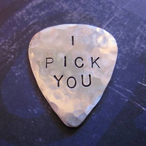 A guitar pick with a personalized message.
