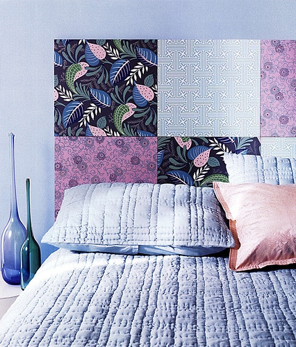Use large sheets of scrapbook paper as a temporary headboard.