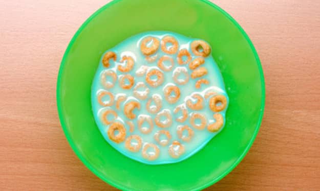 Squeeze a few drops of food coloring into the bottom of your kidâ€™s bowl, then cover it with cereal.