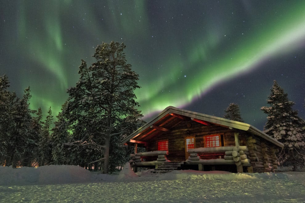This striking cottage under the Northern lights in Lapland, Finland.