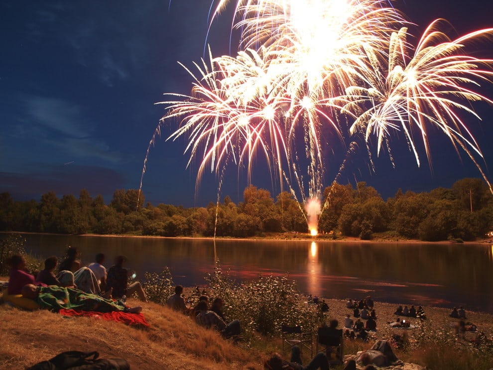 Fireworks burst over the Willamette River on the Fourth of July in Independence, Oregon.