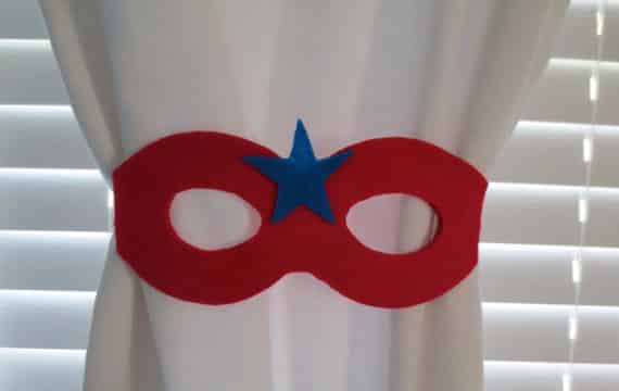Tie back curtains with a superhero mask.