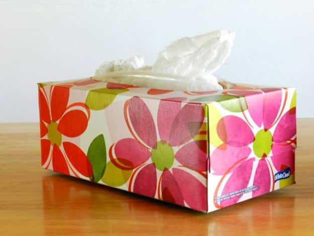 Pack all of those loose plastic grocery bags into an empty (pretty) tissue box, no fancy folding required.