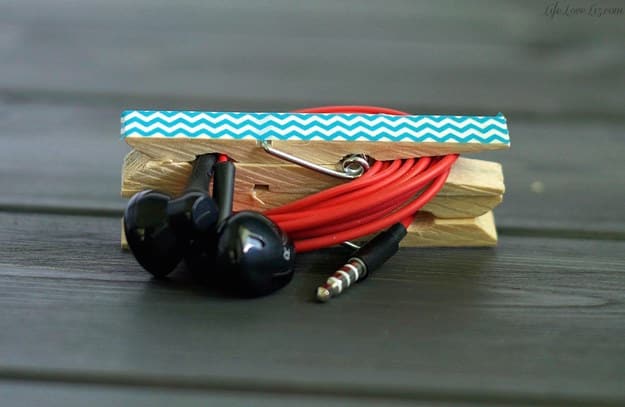 Store your headphones with the help of a couple of clothespins.