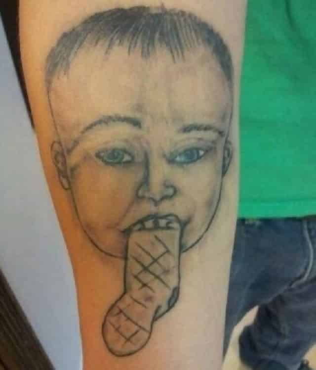 A man has a tattoo of a child on his forearm, but the child has a sock for a tongue
