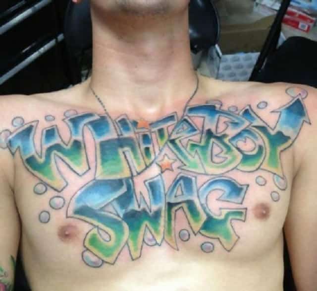 A man with a tattoo on his chest that says “Whiteboy Swag” in graffiti style font 