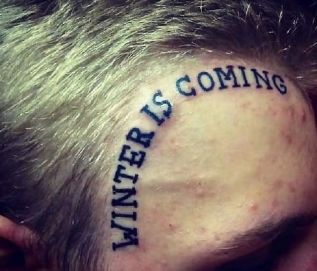 A man with a tattoo on his forehead which says, “Winter is Coming”