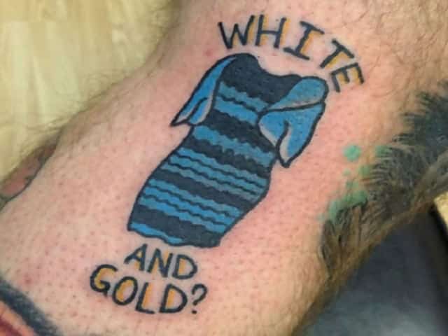 A tattoo of the viral dress that is blue and black but says “White and gold?” around it