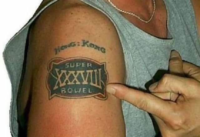 A tattoo on someone’s arm which says “Super Bowel” instead of “Super Bowl”