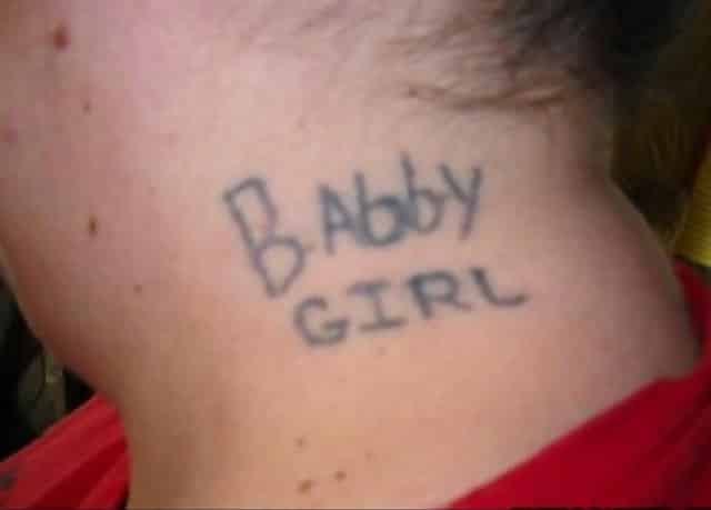 A woman with a tattoo on her neck which says “Babby girl”