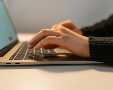 Free A Person Typing on a Laptop Stock Photo